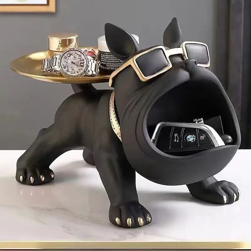 Black dog-shaped jewelry stand with watches and keys on a marble surface