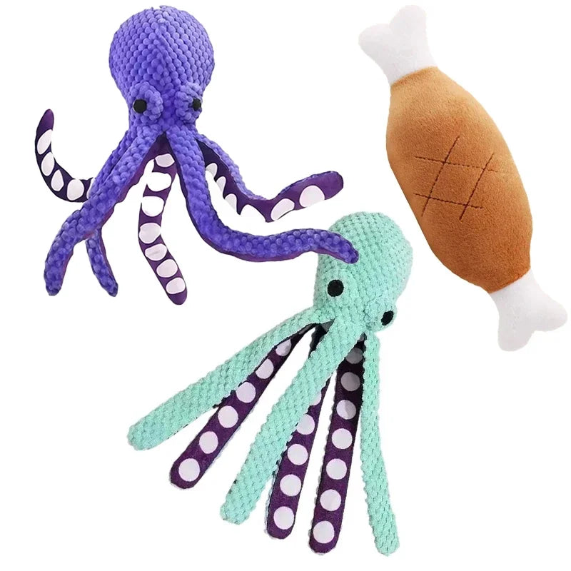 Two plush octopus toys with a fish toy on a white background