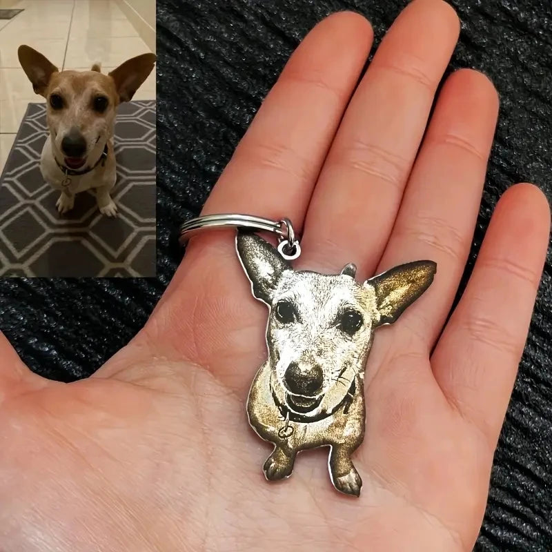 Dog keychain held in a hand with a small inset photo of a dog sitting on a tiled floor.