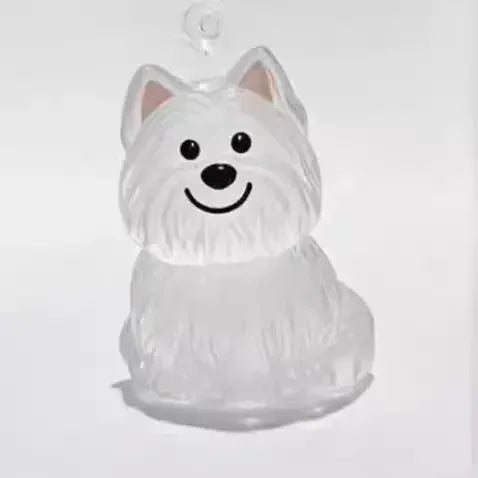 Clear glass ornament shaped like a dog with a white background