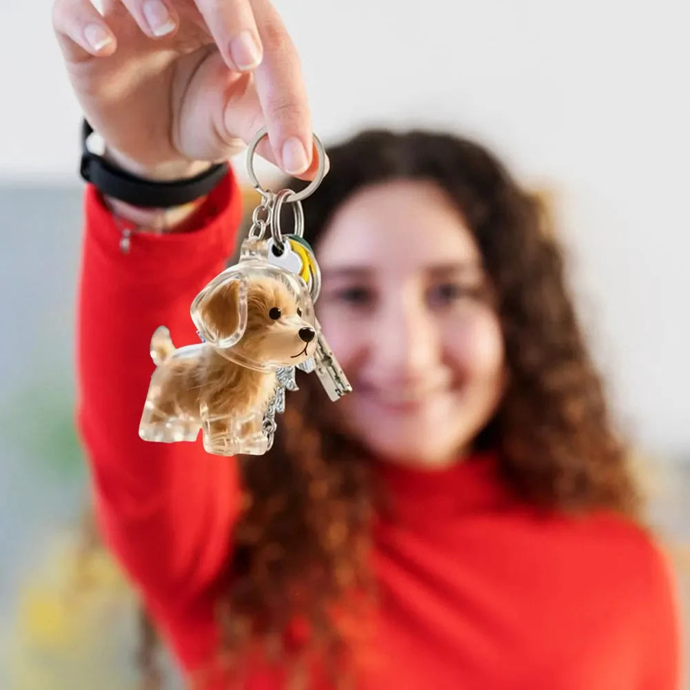 Person holding a dog-shaped keychain with a blurred background