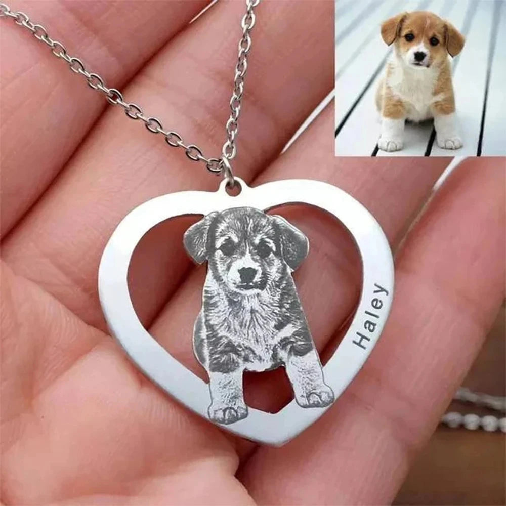 Heart-shaped pendant with a engraved dog illustration and 'Haley' on a hand, with a small inset photo of a puppy.