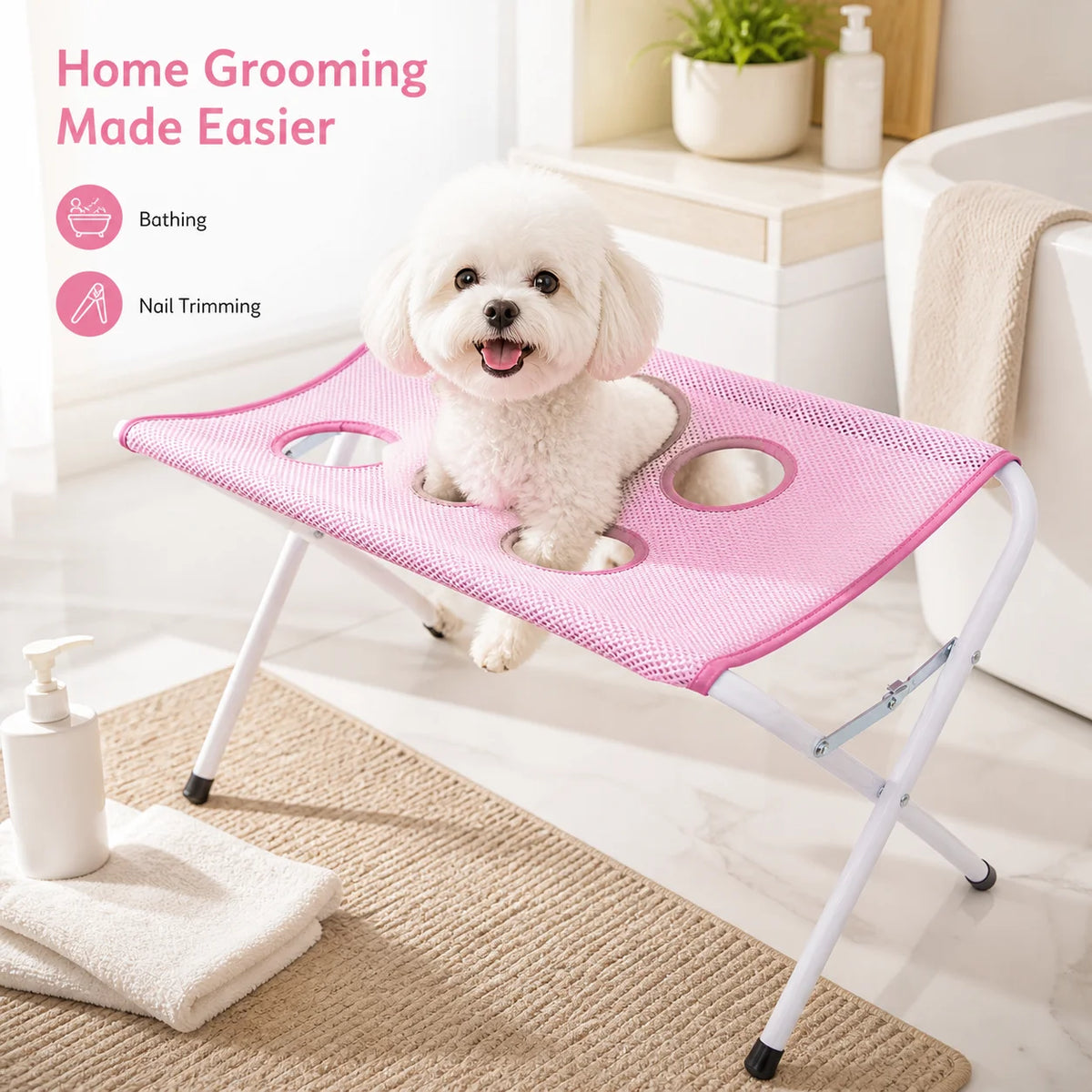 A small white dog sits on a pink mesh pet grooming table with white metal legs in a bright bathroom setting. Pink text on the left reads 'Home Grooming Made Easier' with icons for bathing and nail trimming.
