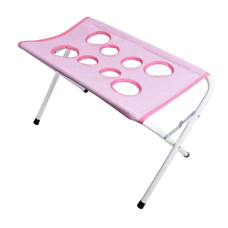 Pink mesh stool with multiple holes on a white background
