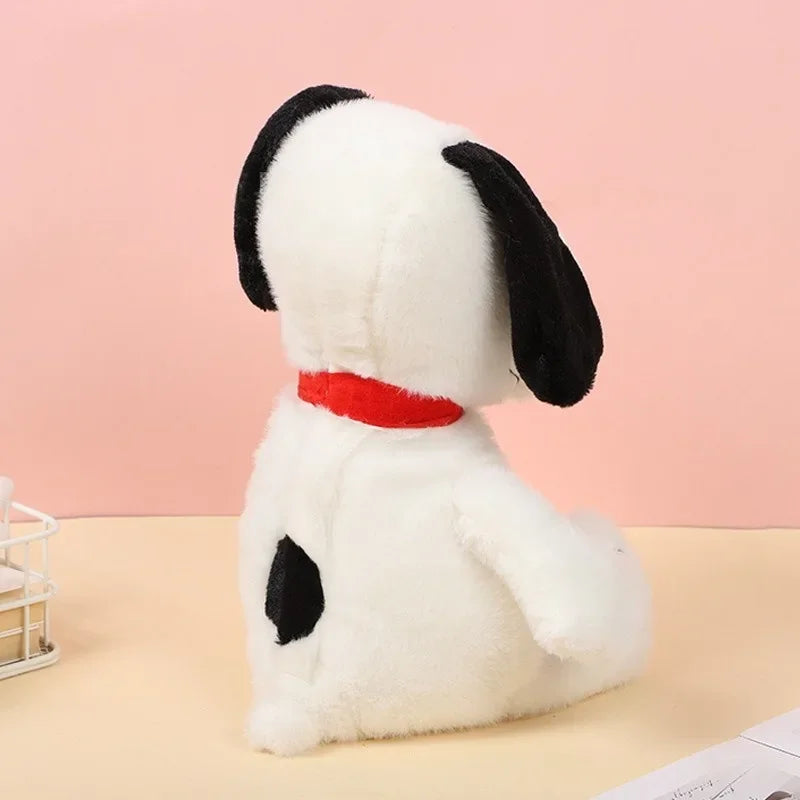 Plush dog toy with a red collar on a pink background