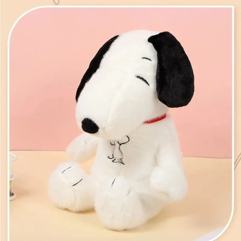 Plush toy resembling a dog with a black and white color scheme on a pink background
